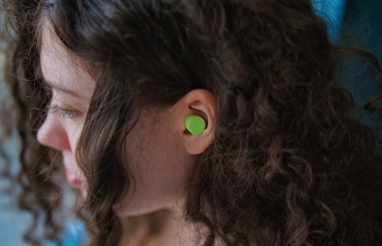Girl wearing ear plug
