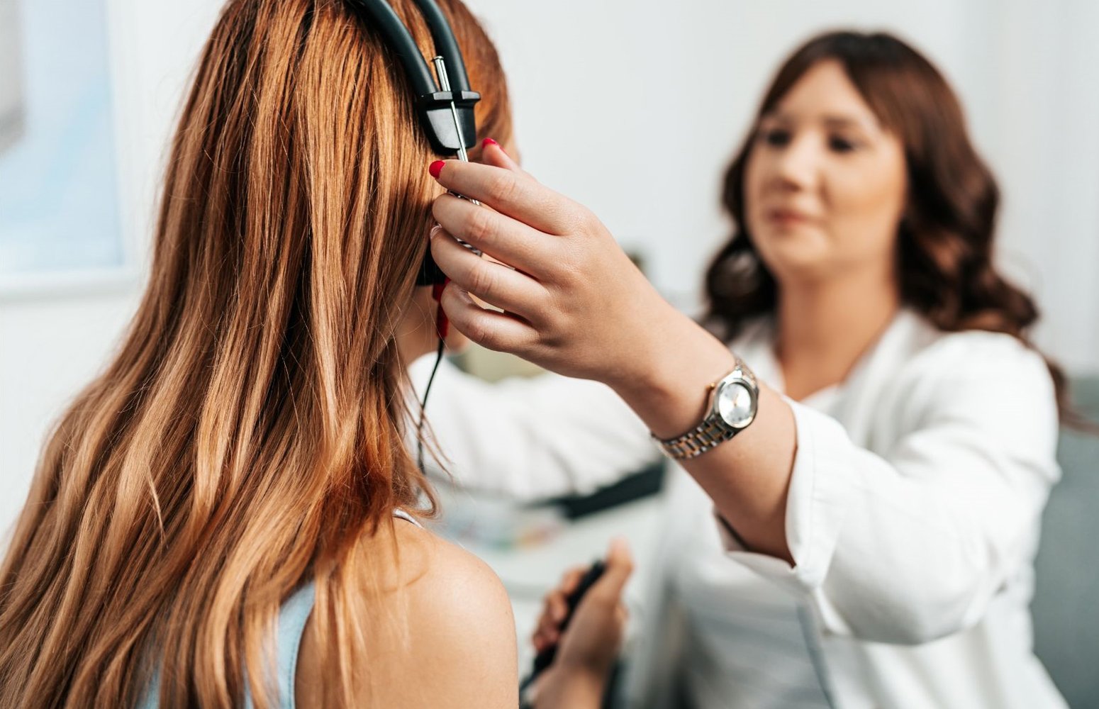 Audiologist conducting a comprehensive hearing assessment with patient wearing audiometry headphones