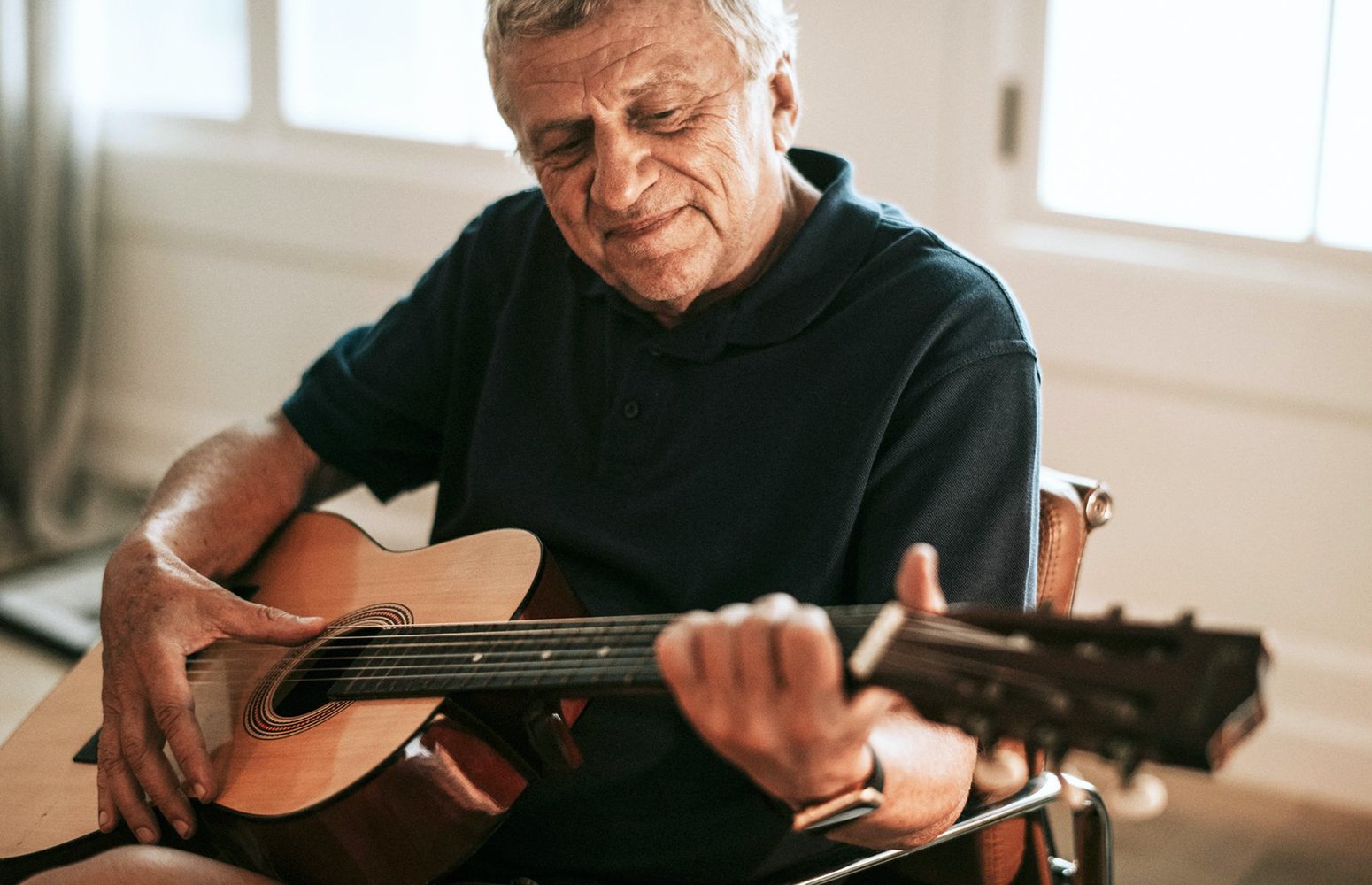 Older man playing guitar
