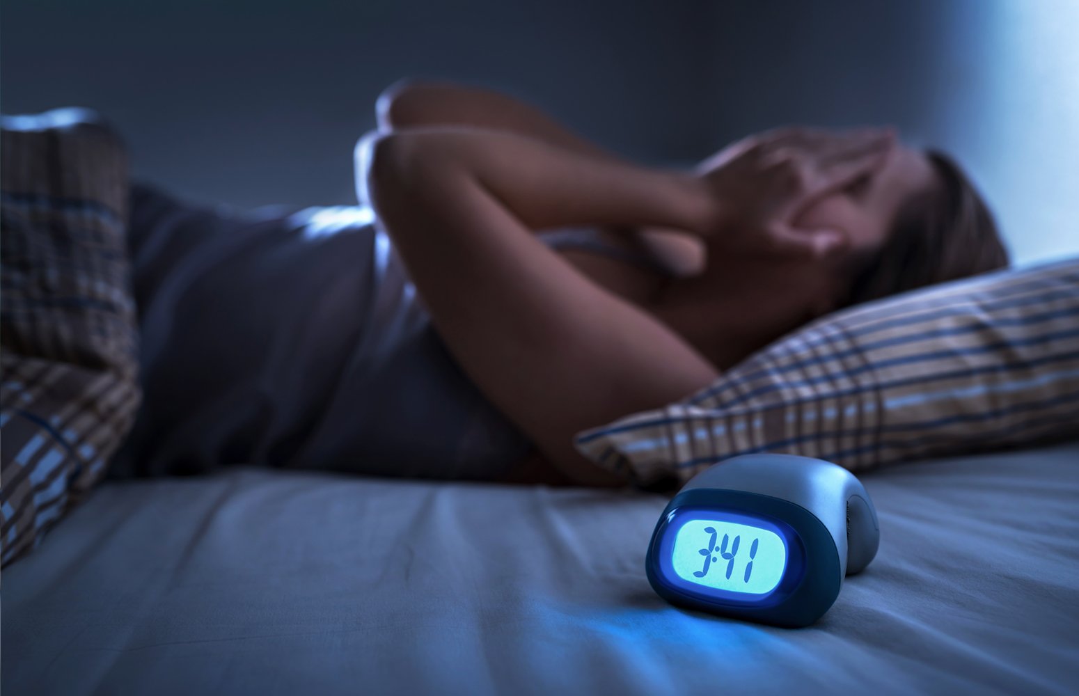 Woman lying awake at night, struggling to sleep